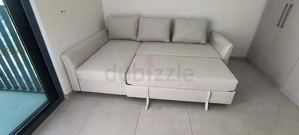 Light beige L-shaped sofa bed with storage - good condition