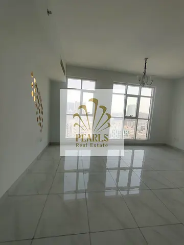 An upscale, front-row apartment on the Ajman Corniche featuring two bedrooms and a living room with