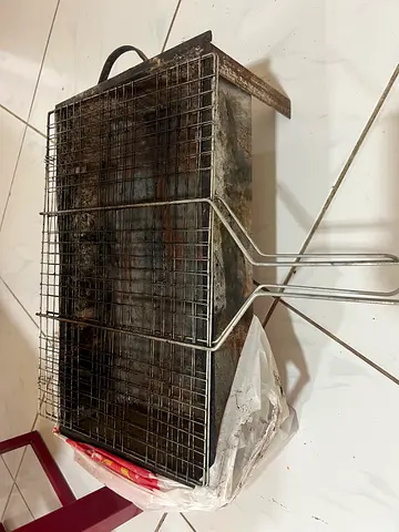 Used portable charcoal BBQ grill with wire rack