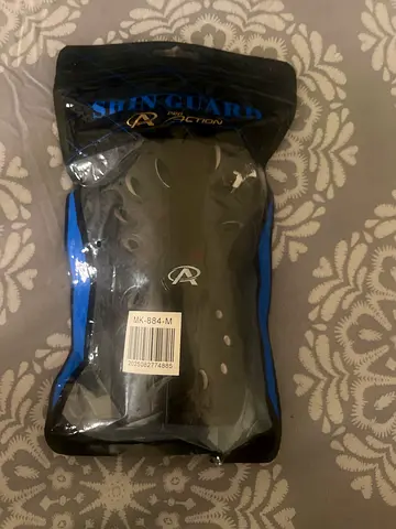 Pair of new shin guards — size M, still in packaging