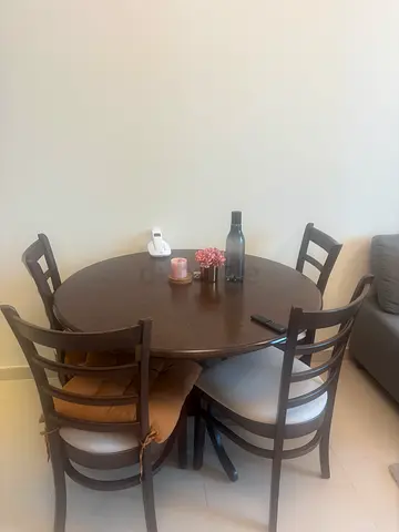 Wooden round dining table with 4 chairs - good condition, scratches on table.