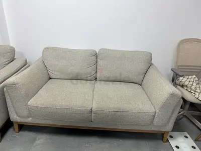 Two-seater light grey fabric sofa in good condition