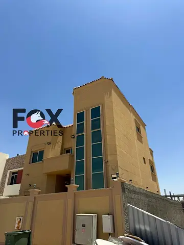 For rent in Al Zahia: a two-story unit with a roof terrace, featuring 4 bedrooms, a majlis, and a living room. Asking price: 95,000. Located opposite