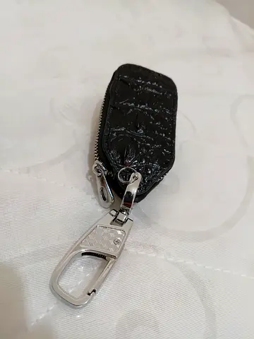 Small black leather key pouch with zipper and metal clip