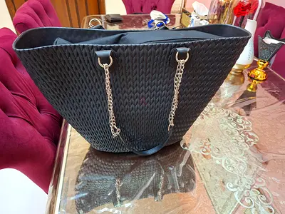 Black woven tote bag with gold chain straps - good condition it's rubber material