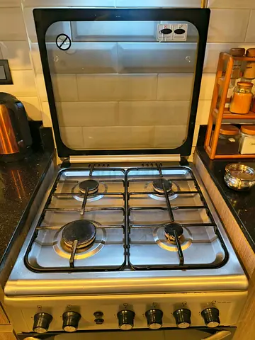 Super General brand 60X60 cms 4-Burner Gas Cooker with Glass Lid and Stainless Finish.