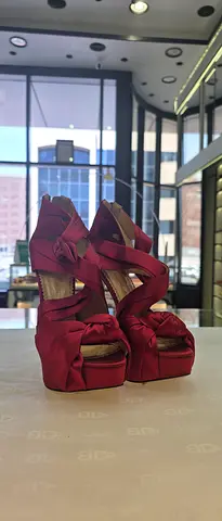 Red satin platform wedge heels with bow detail - size unknown, gently used