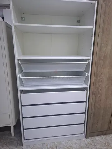 White IKEA-style modular wardrobe drawer unit with pull-out trays