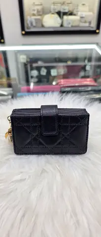 Black quilted mini wallet with zipper and snap closure