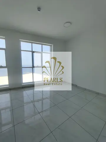 Annual rent in Ajman Corniche Al Bustan, first row. Luxury 3-bedroom apartment with hall, full open view, 3 baths, balcony, wardrobes, central AC.