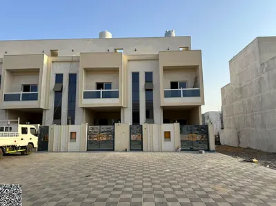 Two-story townhouse with a rooftop terrace in Al Helio, Ajman – Classic design; price includes registration fees and air conditioning units.
