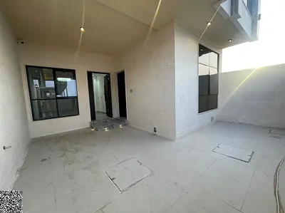 Two-story townhouse with a rooftop terrace in Al Helio, Ajman – Classic design; price includes registration and title transfer fees.