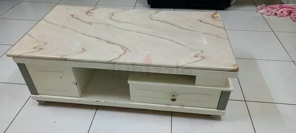Low white marble-top coffee table with storage drawers
