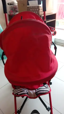 Lightweight red baby stroller (used) - compact and foldable