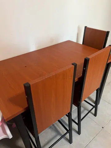 Wooden dining table with two high-back chairs - good condition
