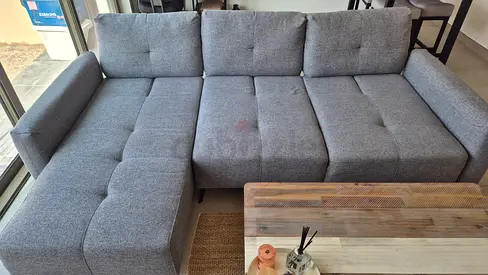 Light grey L-shaped fabric sofa with adjustable width