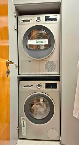 Stacked washer and dryer set — compact front-load units, nearly new