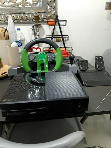 Xbox 1 with steering wheel and game cds
