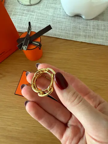 Hermès Gold Tone Interlocking Knot Pendant / Charm