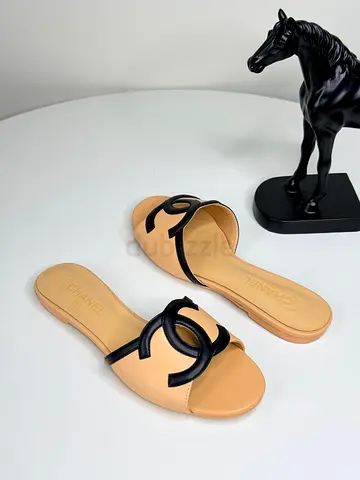 Beige leather slip-on sandals with black logo detail - used