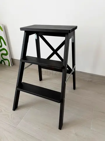 Compact black wooden Ikea side table with shelf, ladder