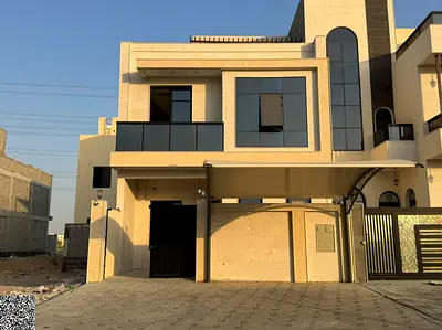 Two-story townhouse with a rooftop terrace in Al Helio, Ajman – Classic design; price includes registration and title transfer fees.