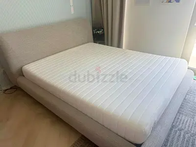 Queen-size fabric bed frame with foam mattress included
