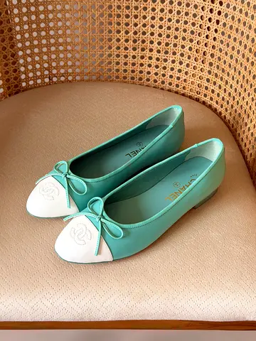 Light teal Chanel-style ballet flats with white cap toe, size not specified