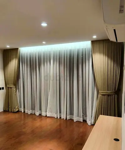 Full-length beige blackout curtains with sheer inner panels - set