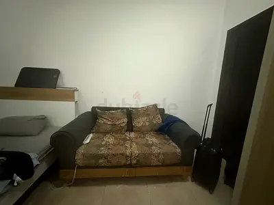 Two-seater fabric sofa with patterned cushions - good condition