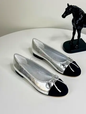 Silver leather ballet flats with black cap toe — size not specified