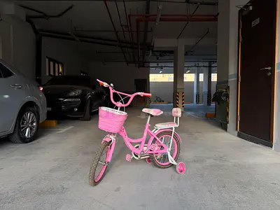 Kids bicycle with training wheels attached