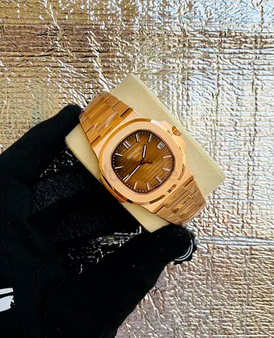 The warm 18K rose gold finish and chocolate brown sunburst dial give this Patek Philippe Nautilus Re