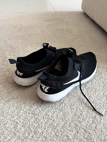 Black Nike casual sneakers, lightly used, size unknown