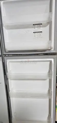 Used double-door refrigerator (interior shelves and door bins included) bought new