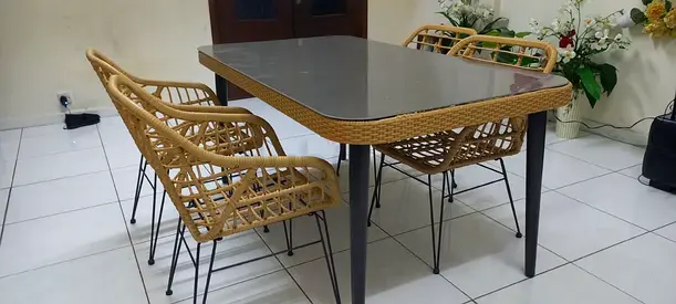 Rattan-style dining table with 4 woven chairs - good condition
