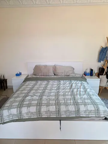 White platform bed with headboard and bedside tables - good condition