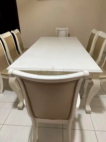 Elegant White Dining Table with 8 Upholstered Chairs. Some wear and tear, can be easily fixed.