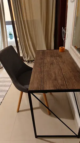 Wood-look desk with grey upholstered chair — good condition