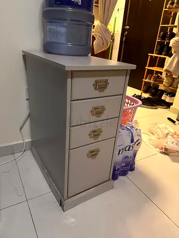 Small grey wooden bedside cabinet with 3 drawers and cupboard