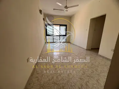 Two-bedroom apartment with a living room and balcony offering an open view; spacious layout with sandy parking available.