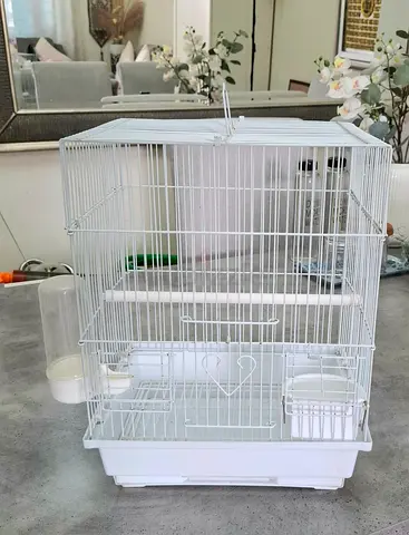 White metal bird cage with perches and feeding cups - good condition