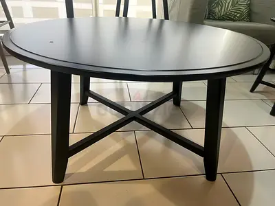 Solid Black Round Coffee Table with Cross Legs - Good Condition