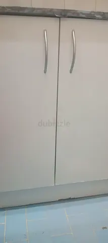 White kitchen base cabinet with double doors and countertop