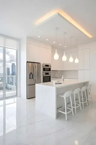 Modern white kitchen island with pendant lights and bar stools