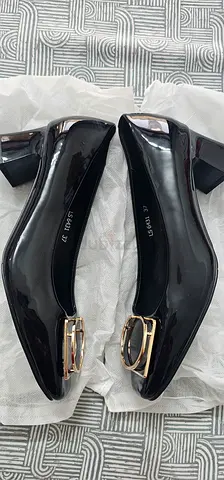 Black patent low-heel pumps with gold buckle, size 37