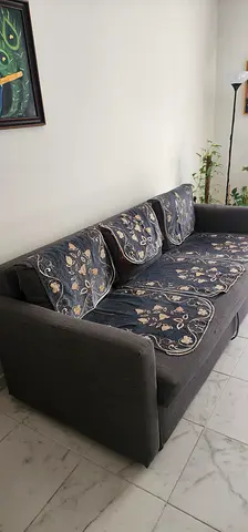 Large 3-Seater Grey Fabric Sofa Cum Bed with Floral Cushions and storage space - Good Condition