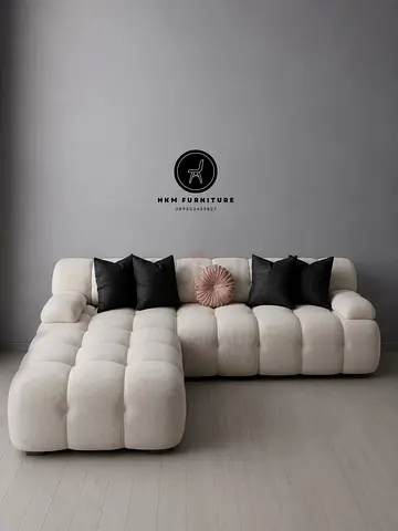 Modern L-shaped tufted sectional sofa in cream — left chaise