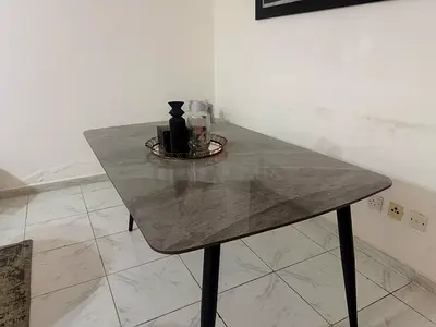 Modern grey marble-effect dining table with black legs - good condition