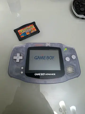 Transparent Game Boy Advance with Pokemon FireRed cartridge - Good Working Condition